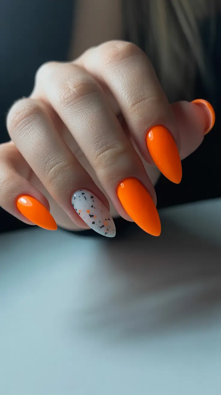 trendy neon nails 2026 Orange Pop With Terrazzo Accent