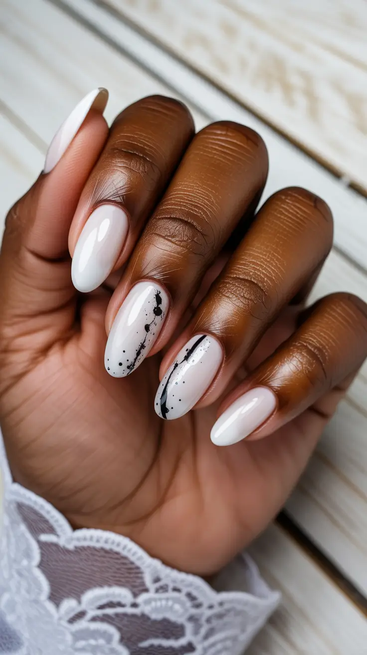 summer nail colors ideas 2026 for dark skin Milky White with Artistic Ink Splatter Accents