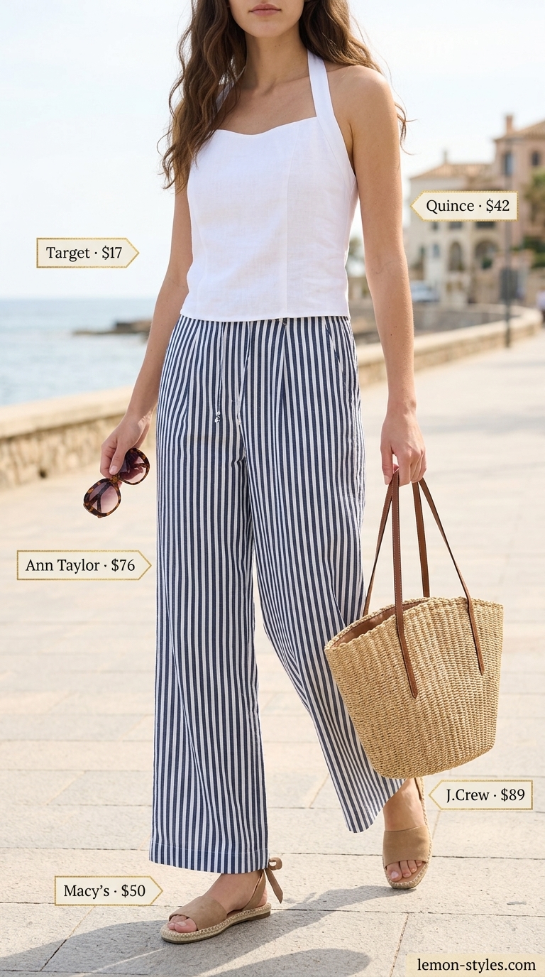 Sophisticated white halter top with navy stripe wide pants for women 2026. Seaside brunch style.