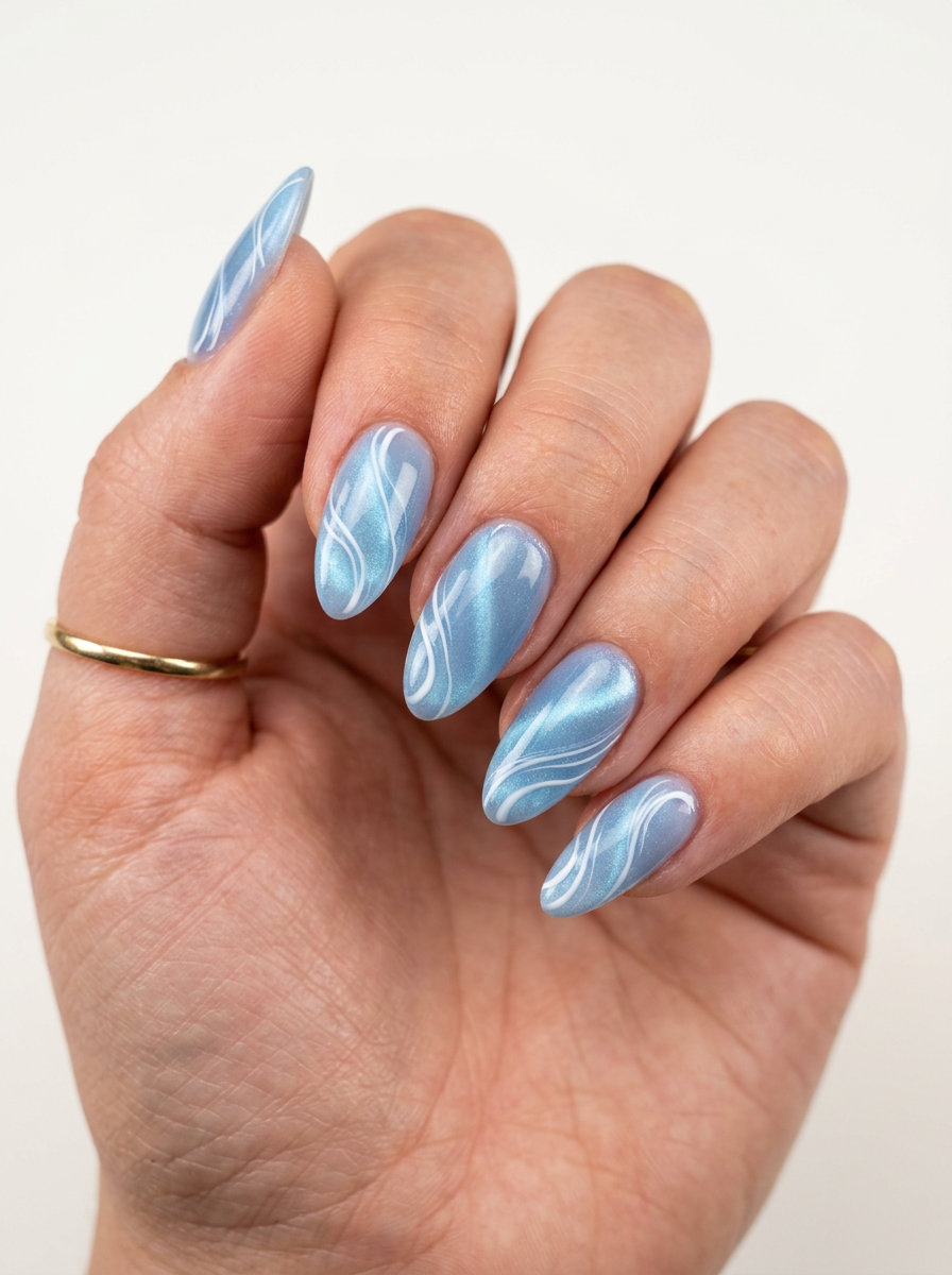 Baby Blue Cat Eye Swirls 2026 | Sultry Date Night Baby blue cat-eye swirl nails for date night and summer romance. Blue summer nails 2026.