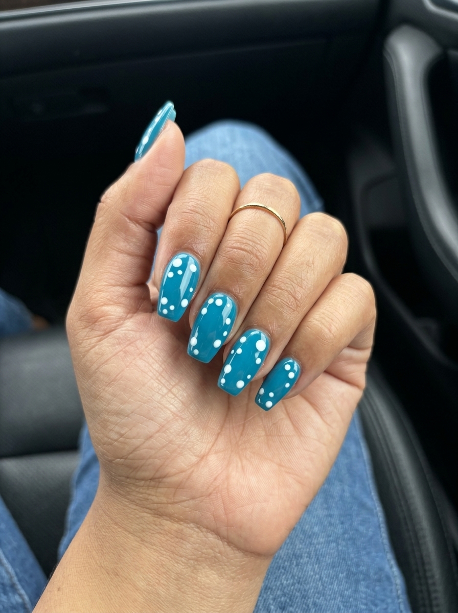 Coastal Dotty Delight: Blue Summer Nails 2026 Teal and white dots on coffin nails. Fun blue summer nails 2026 for beach parties.