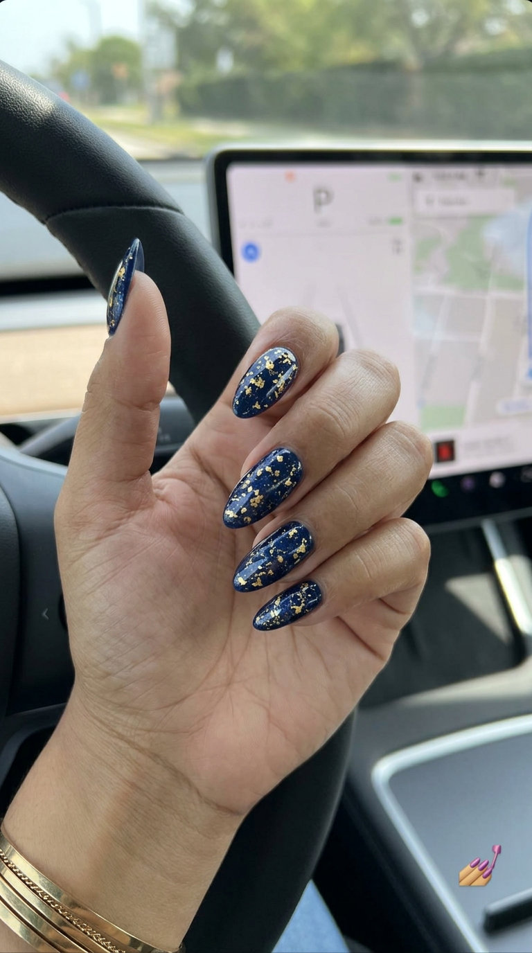 Cute summer nails 2026: Cosmic gold dust navy on almond nails for parties and date nights. Glamorous.