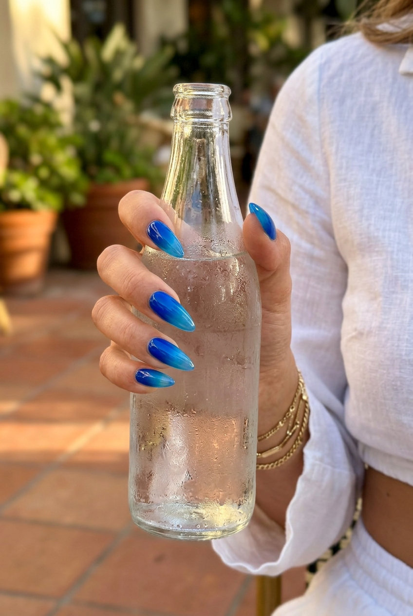 Fun Summer Nails 2026: Electric Blue Jelly Electric blue jelly gradient stiletto nails for fun summer nails 2026. Edgy for festivals and beach parties.