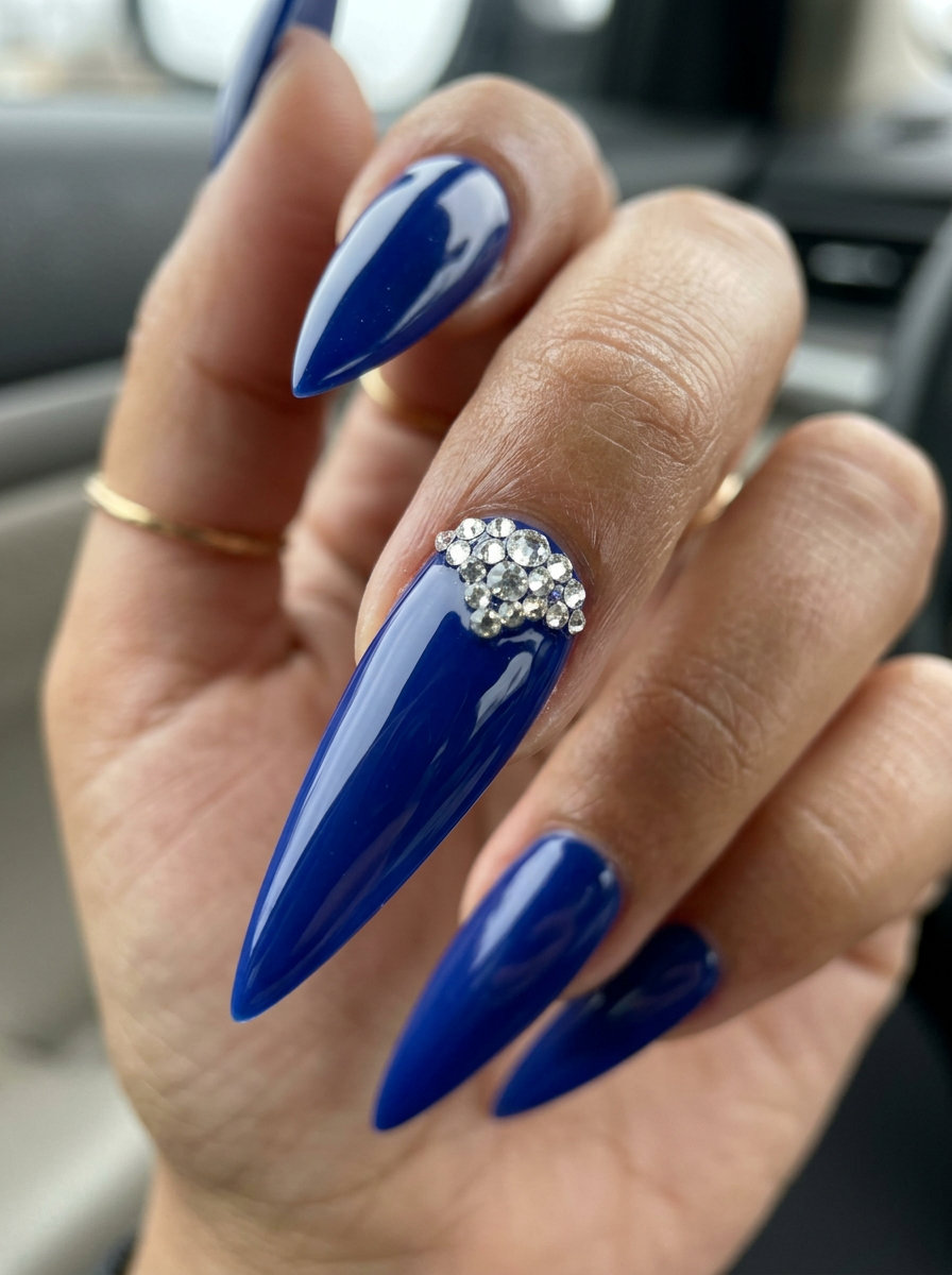 Sapphire Sparkle nails: cobalt blue with crystal rhinestones, coffin shape, party glam. June manicure ideas - summer trends 2026.
