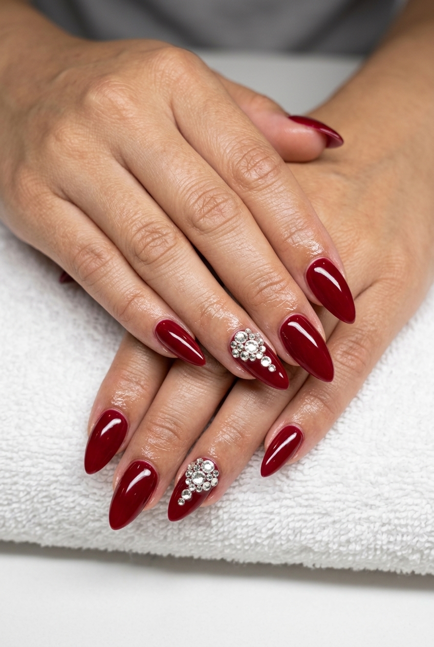 Long summer nails 2026: Glamorous cherry red stiletto with rhinestone accents for parties.