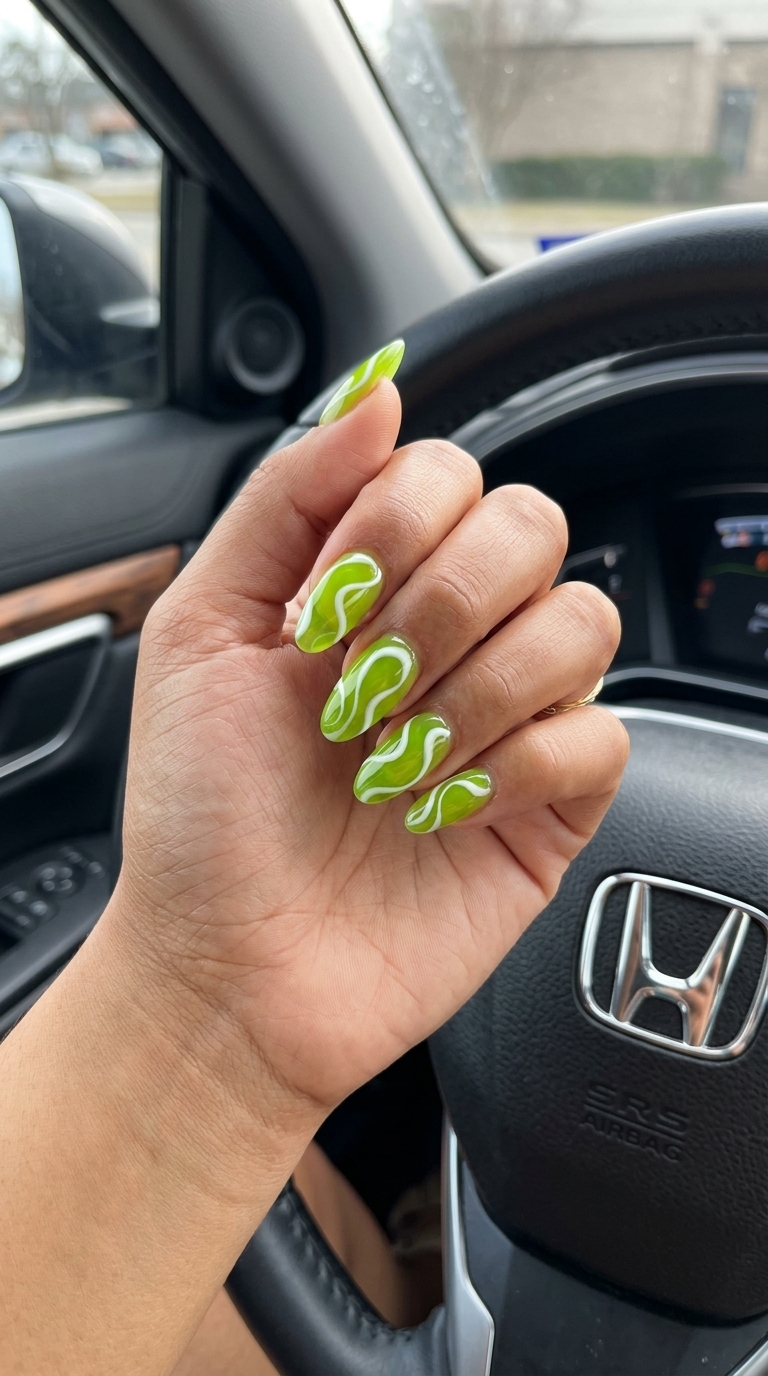 Long summer nails 2026: Psychedelic lime green jelly swirls on oval nails for festivals and parties.