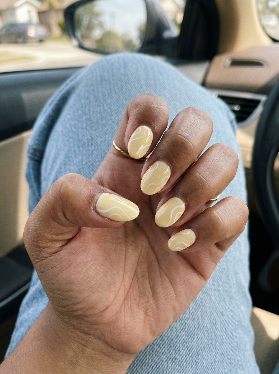 Butter Yellow Swirl Oval Nails | Summer 2026 Art Abstract Butter Yellow Swirls for oval summer nails 2026, ideal for casual outings and brunch. Playful art.