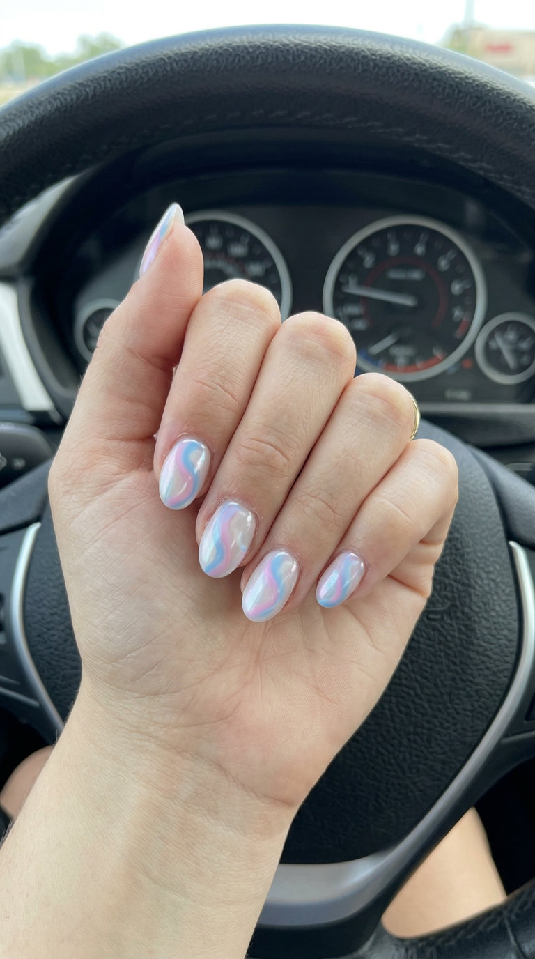 Pearlescent Swirl Nails 2026 | Dreamy Summer Style Short oval summer nails 2026: Pearlescent swirls in pastel blue and pink for a dreamy, whimsical casual look.