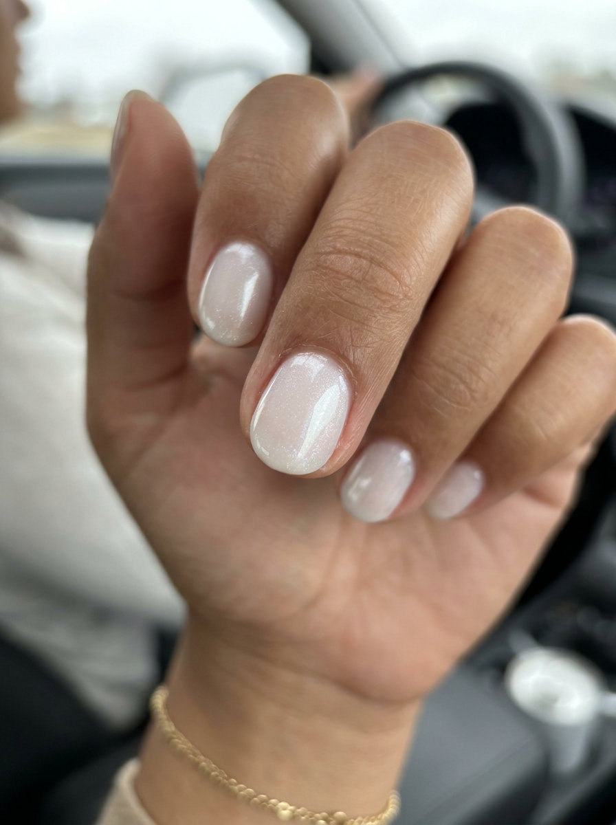 Ethereal sheer white shimmer oval nails for solid summer nails 2026. Minimalist clean-girl work style.