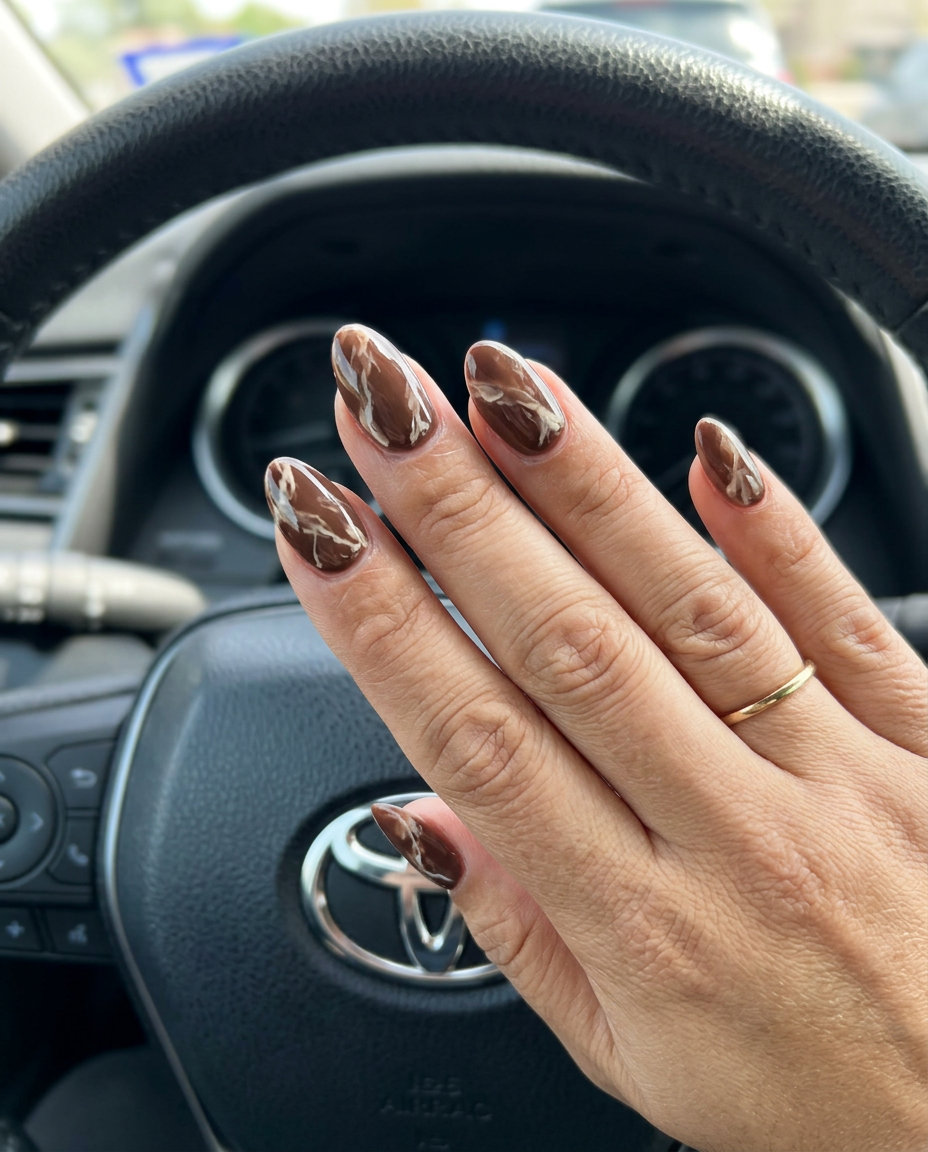 Chocolate Brown Marble Almond Nails 2026 Chic chocolate brown marble almond nails for summer almond nails 2026. Luxurious for events & daily wear.