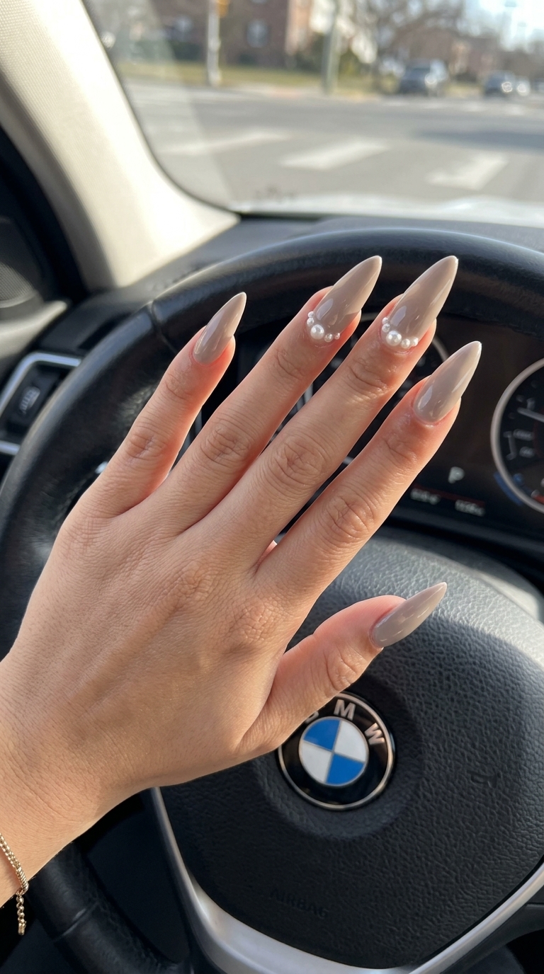 Summer classy nails 2026: Greige stiletto nails with ivory pearl embellishments for formal events.