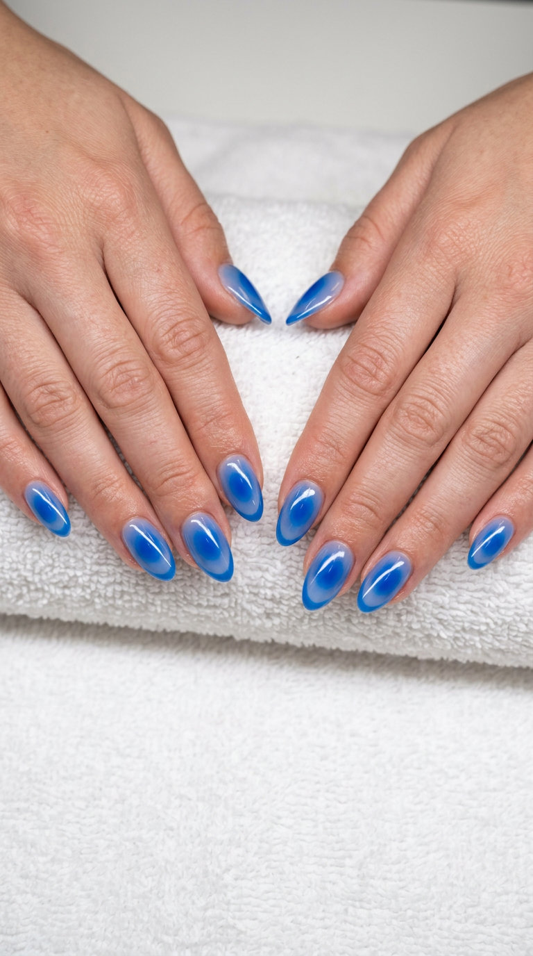 Sheer natural nails with an electric blue aura for summer colorful nails designs 2026. Futuristic date night look.