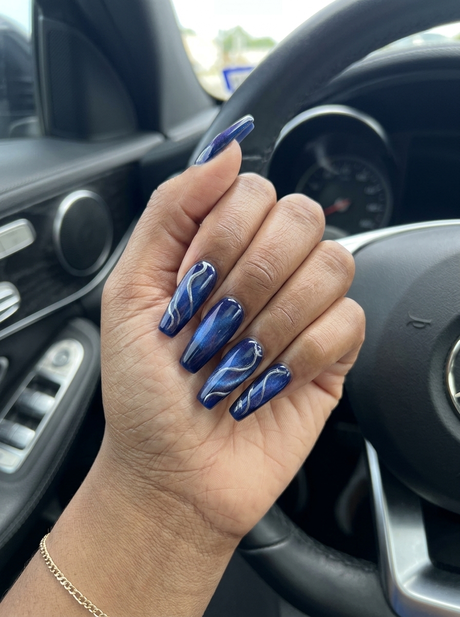 Sapphire Cat-Eye Swirl Nails 2026: Evening Sapphire blue cat-eye swirls nails for evenings 2026. Sultry, mysterious formal style.