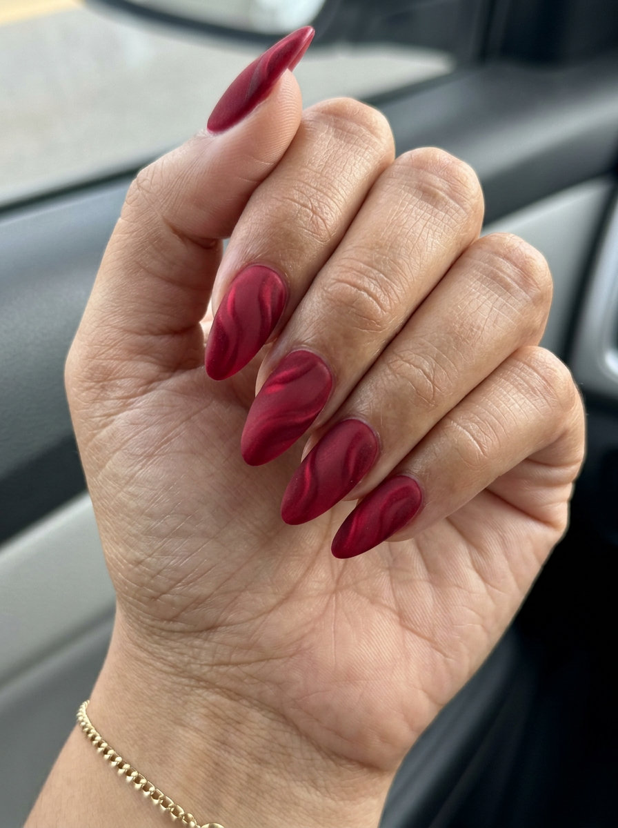 Summer Red Nails 2026: Velvet Crimson Swirl Sultry velvet crimson swirl almond nails for a sophisticated summer 2026 date night. Mysterious.