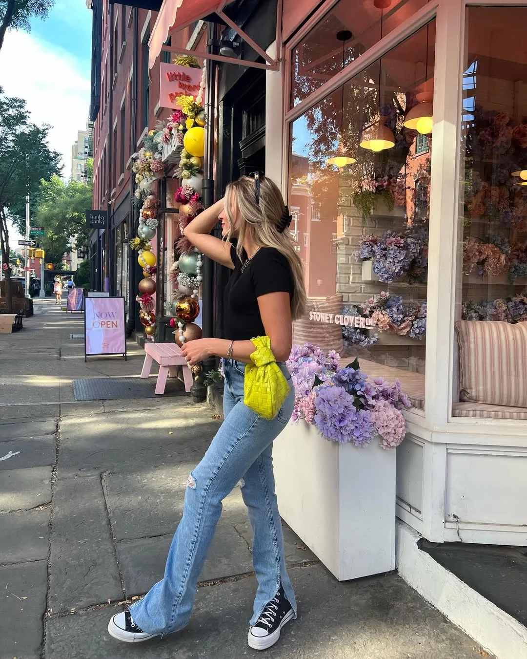 fall outfits with sneakers and jeans 2026 Black Tee and Flared Denim with a Pop of Color