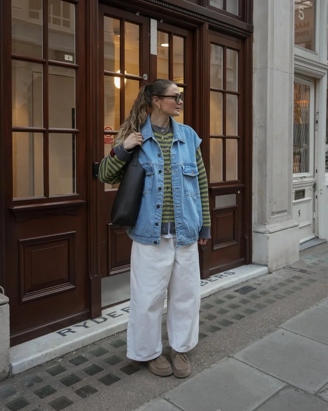 fall outfits with sweater 2026 Layered Denim Vest Brings New Life to a Striped Sweater