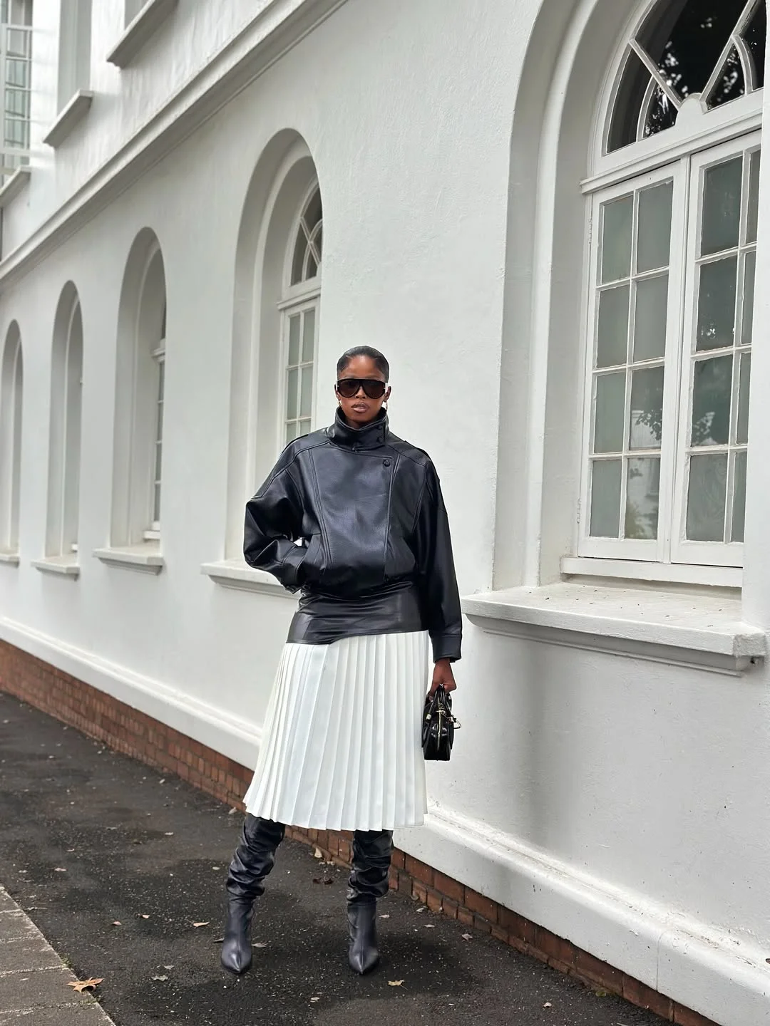 fall outfits with tights and skirt 2026 White Pleats and Black Leather for High Contrast Elegance