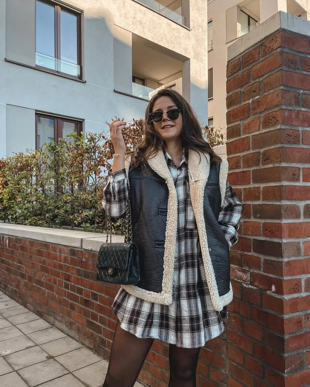 fall vest outfits for women 2026 Layering a Shearling Leather Vest Over a Plaid Mini Dress