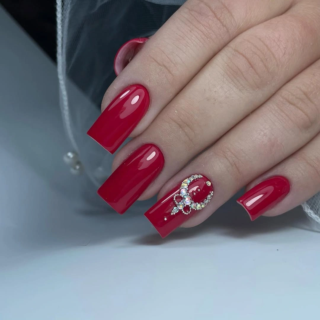 august nails ideas 2026 Bold Ruby Red Nails with Elegant Crystal Accents