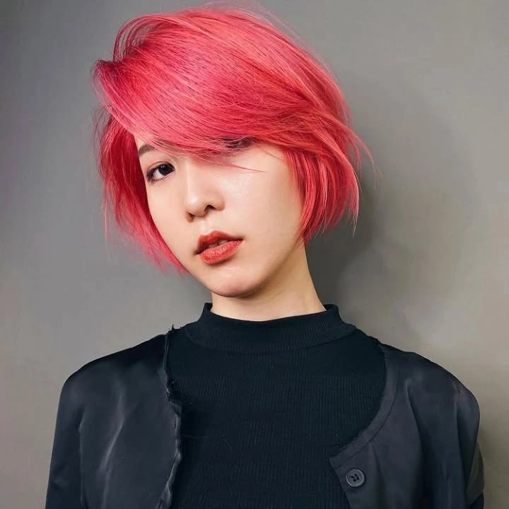 bobbed haircut for women Playful Coral Pink Layered Bob with Sweeping Side Fringe
