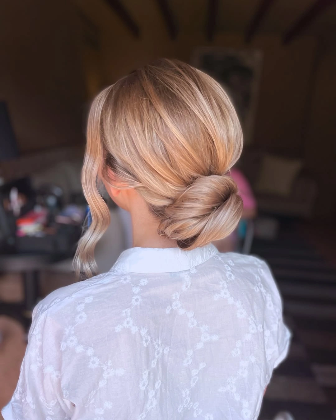 bridesmaid hairstyling Minimalist Low Chignon with a Sleek Finish
