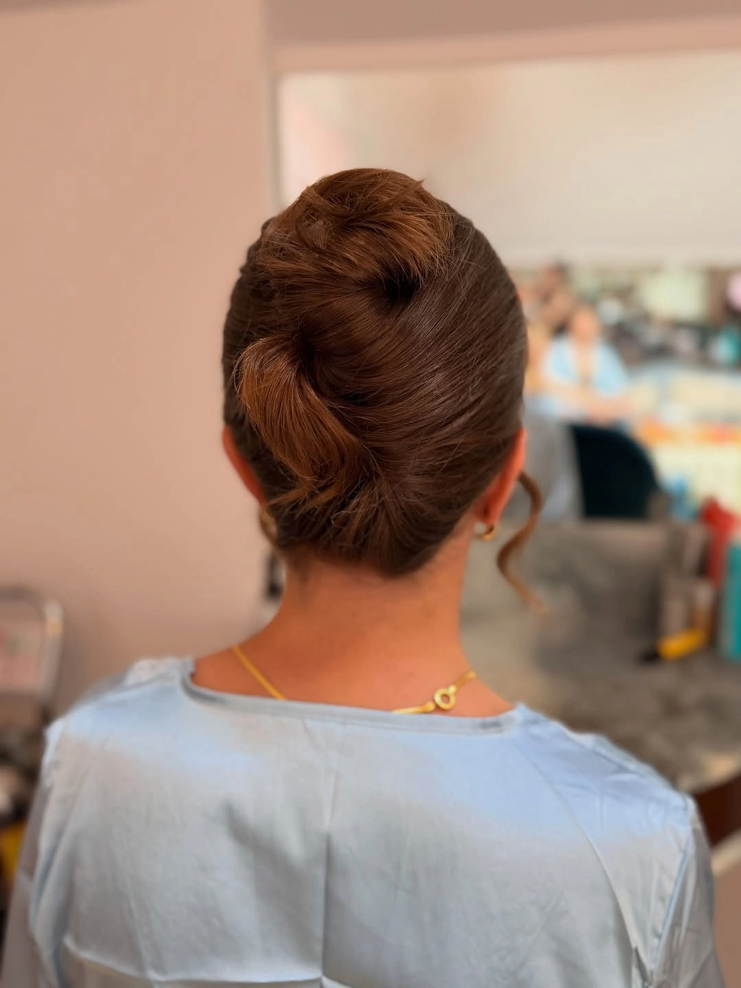 bridesmaid hairstyling Modern Twisted Chignon with Minimalist Appeal