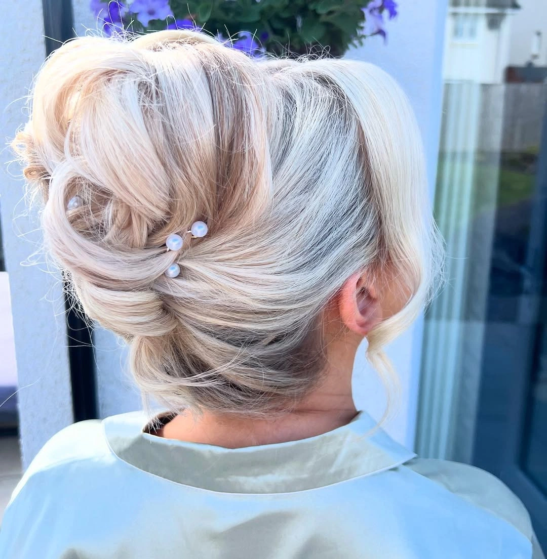 bridesmaid hairstyling An Elegant Low Chignon with Pearls