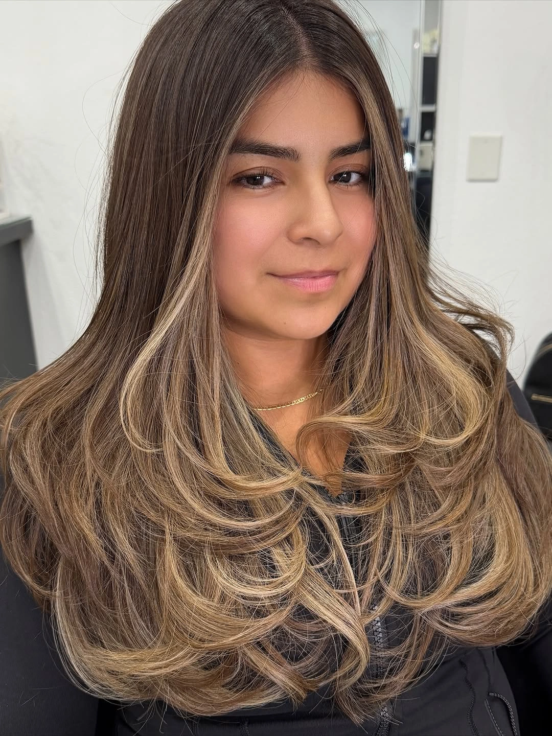 dimensional brunette hair color Face-Framing Beige Brunette with Luxurious Butterfly Layers
