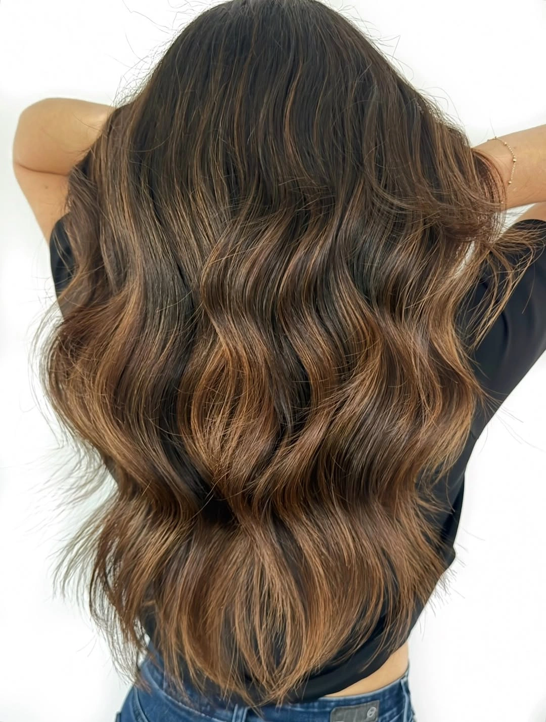 dimensional brunette hair color Warm Caramel Brunette with Cascading Beach Waves