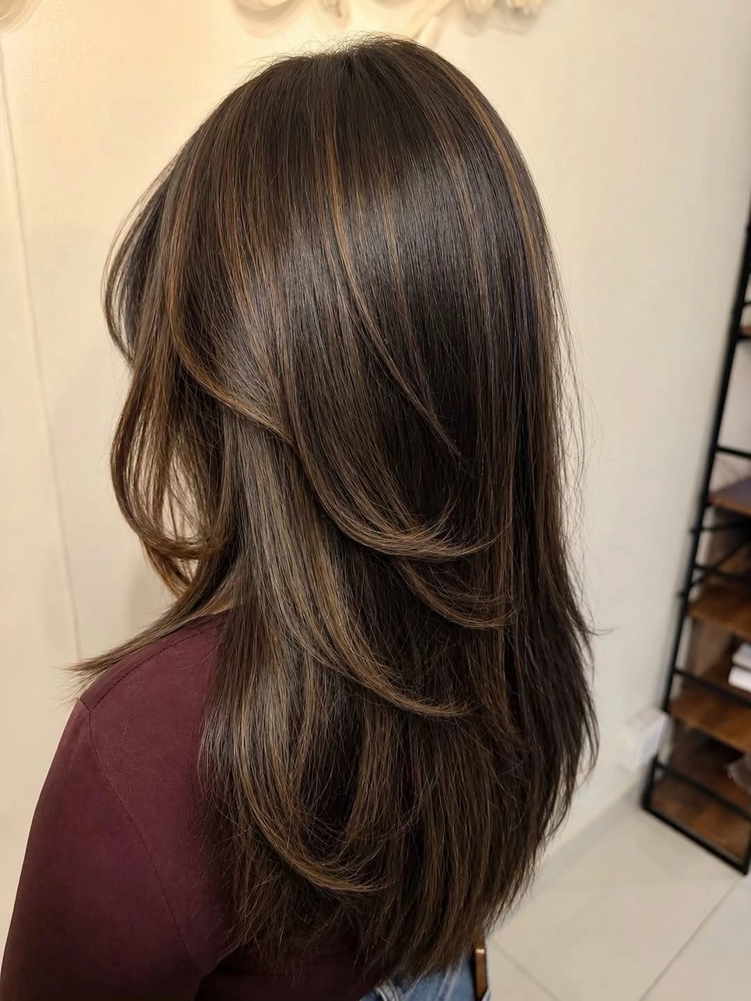 dimensional brunette hair color Layered Brunette Movement with Face-Framing Brightness