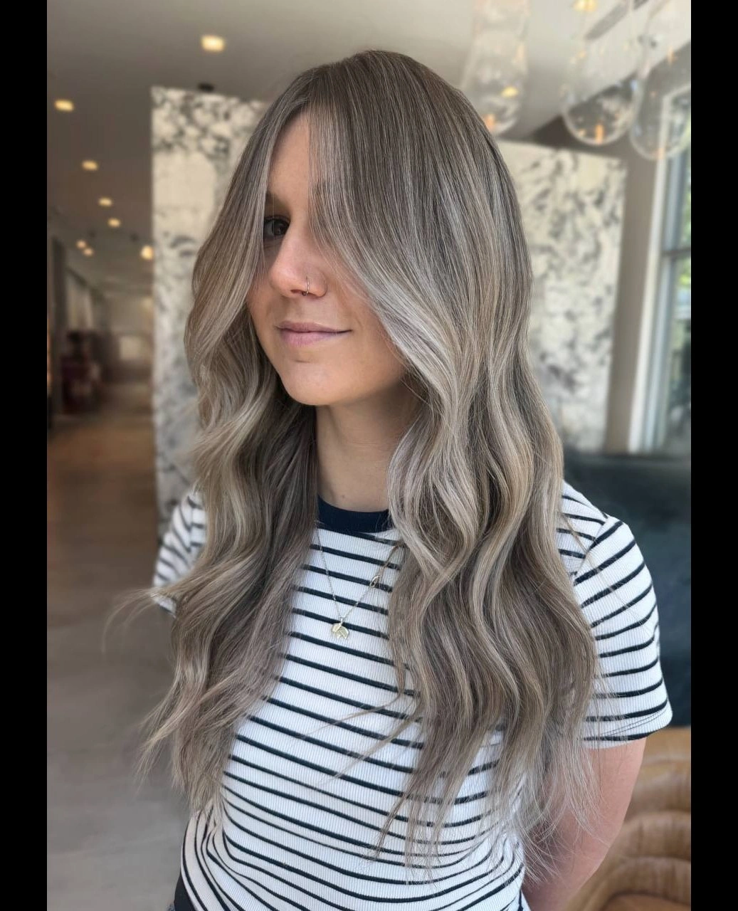 dirty blonde hair color Silvery Dirty Blonde Waves With a Modern Ash Finish