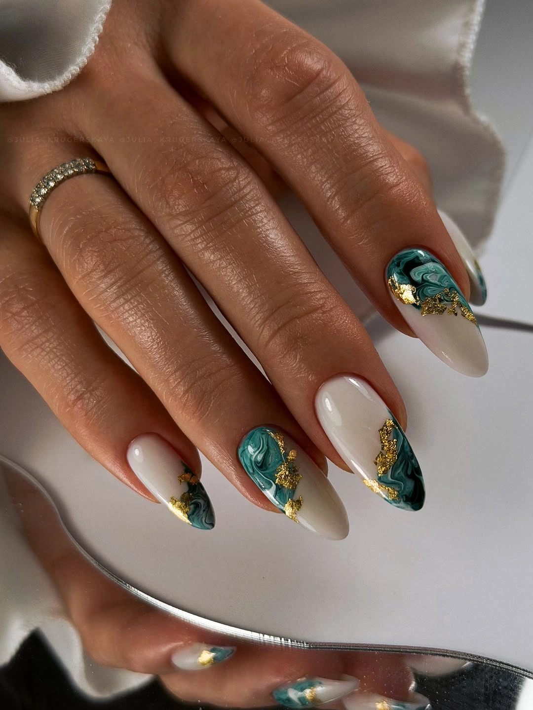 teal marble almond nails with gold details