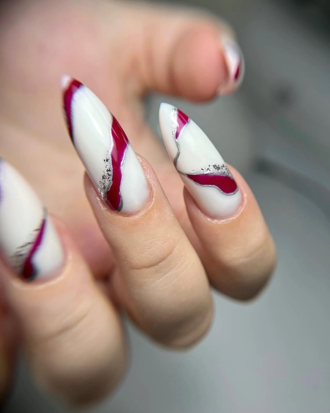 white almond nails with burgundy ribbon lines