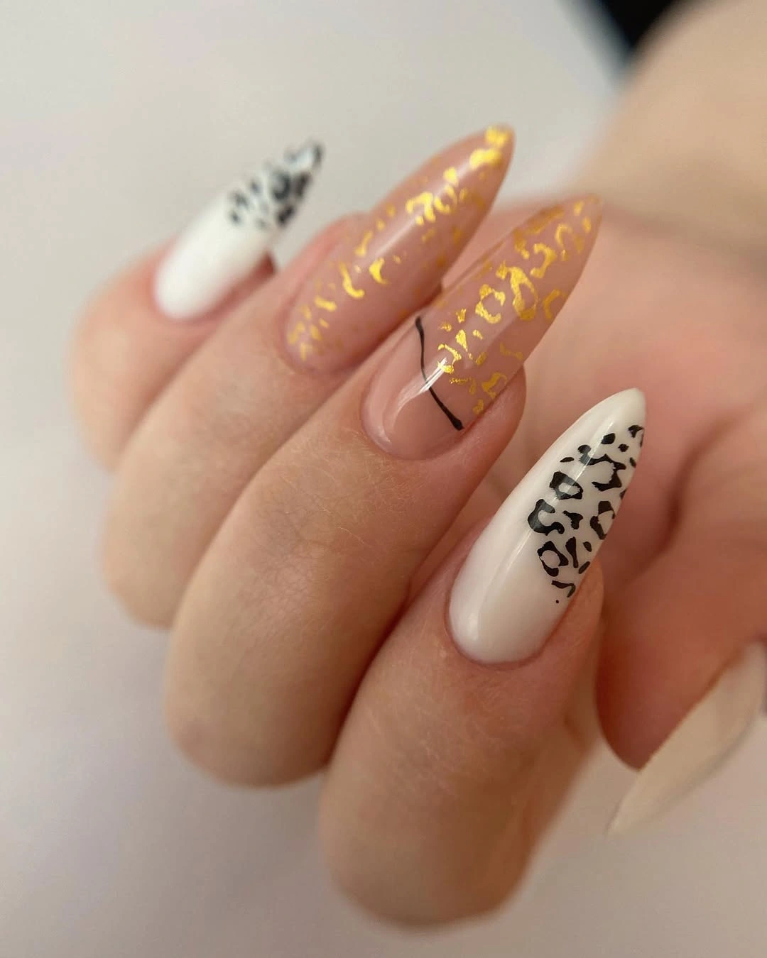 mixed animal print almond nails with gold accents