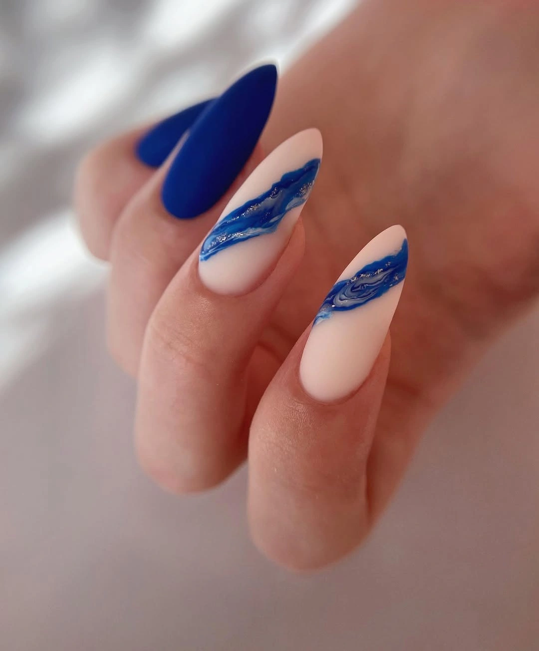 deep blue marble accent almond nails