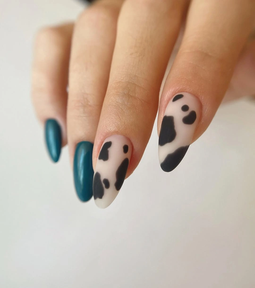 teal almond nails with black spotted accents