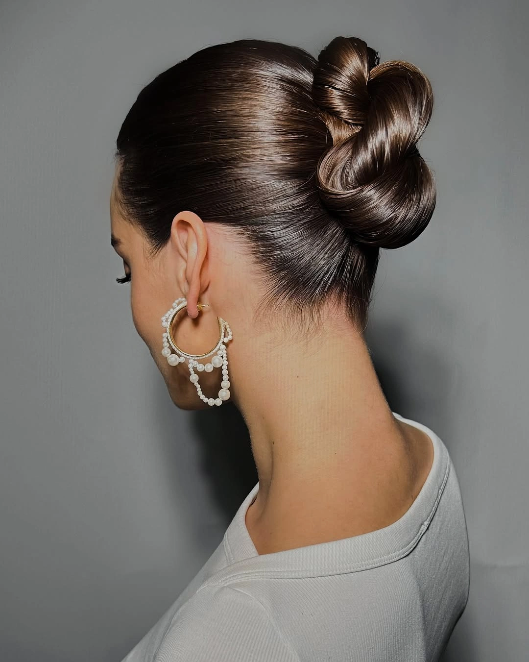 Fall hairstyles for office 2026 Glossy Sculptural Bun with Sleek Office Finish