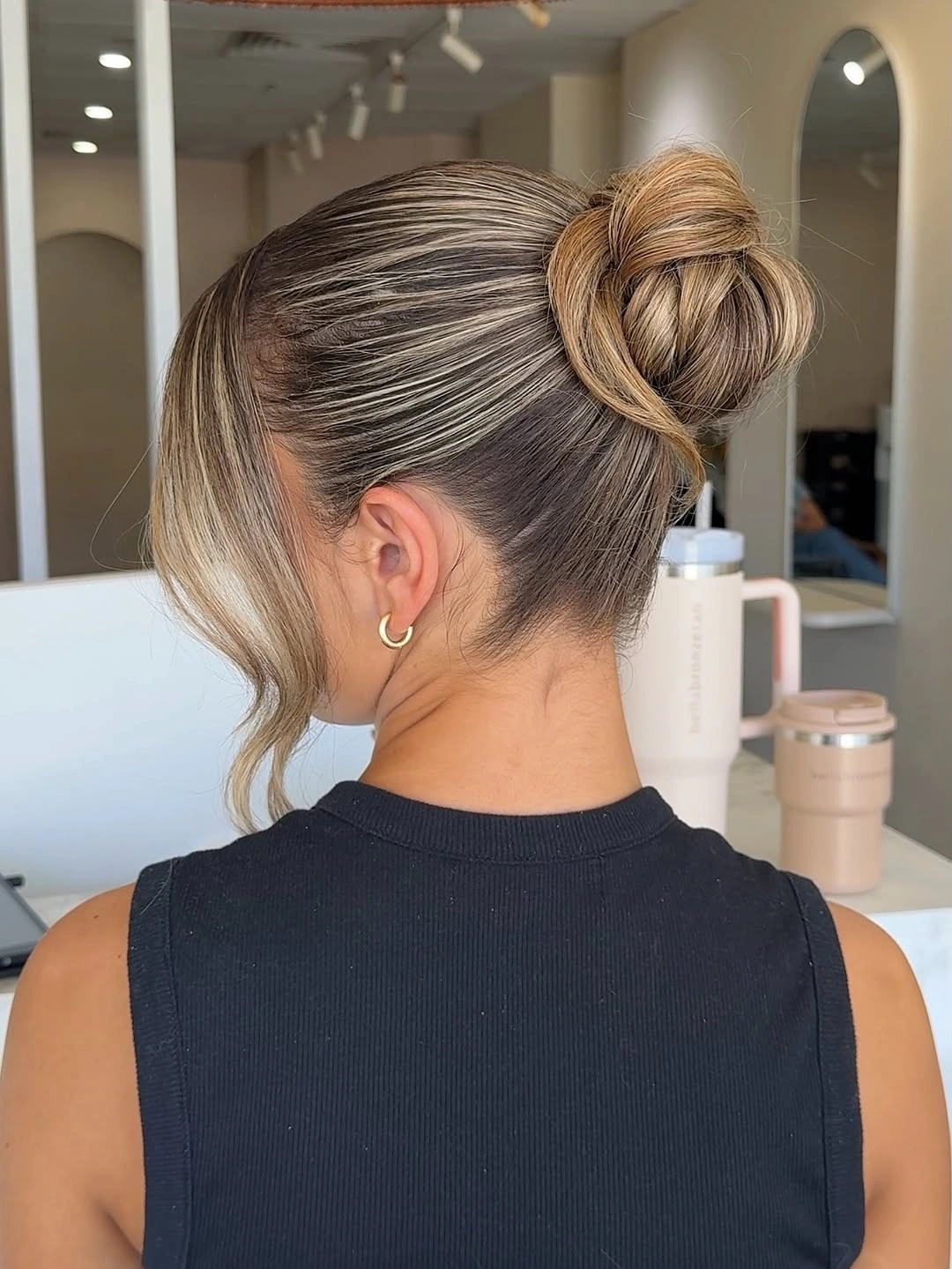 Fall hairstyles for office 2026 Sleek Wrapped Office Bun with Blonde Dimension