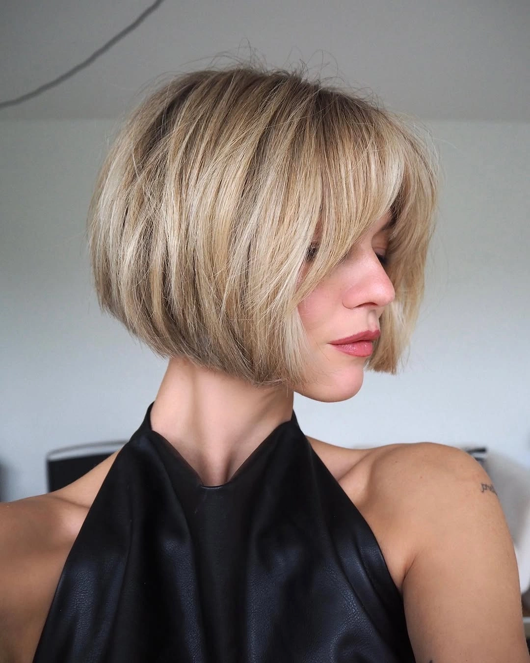 Fall hairstyles for short hair 2026 Soft Layered Blonde Bob with Airy Curtain Bangs