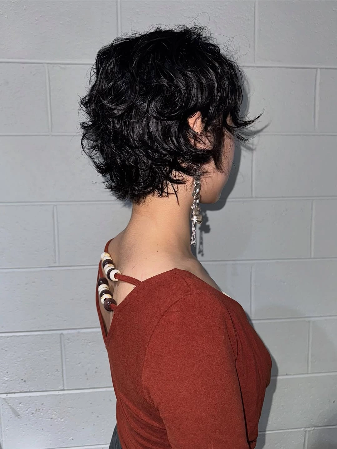 Fall hairstyles for short hair 2026 Tousled Curly Pixie Bob with Feathered Layers