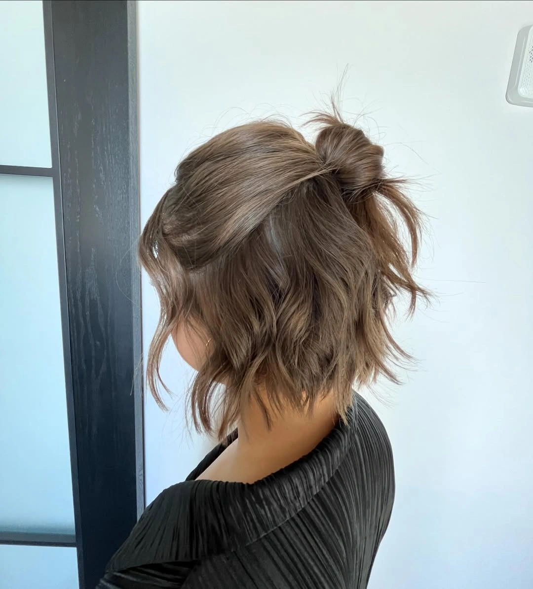 Fall hairstyles for short hair 2026 Relaxed Half-Up Mini Bun for Textured Short Hair