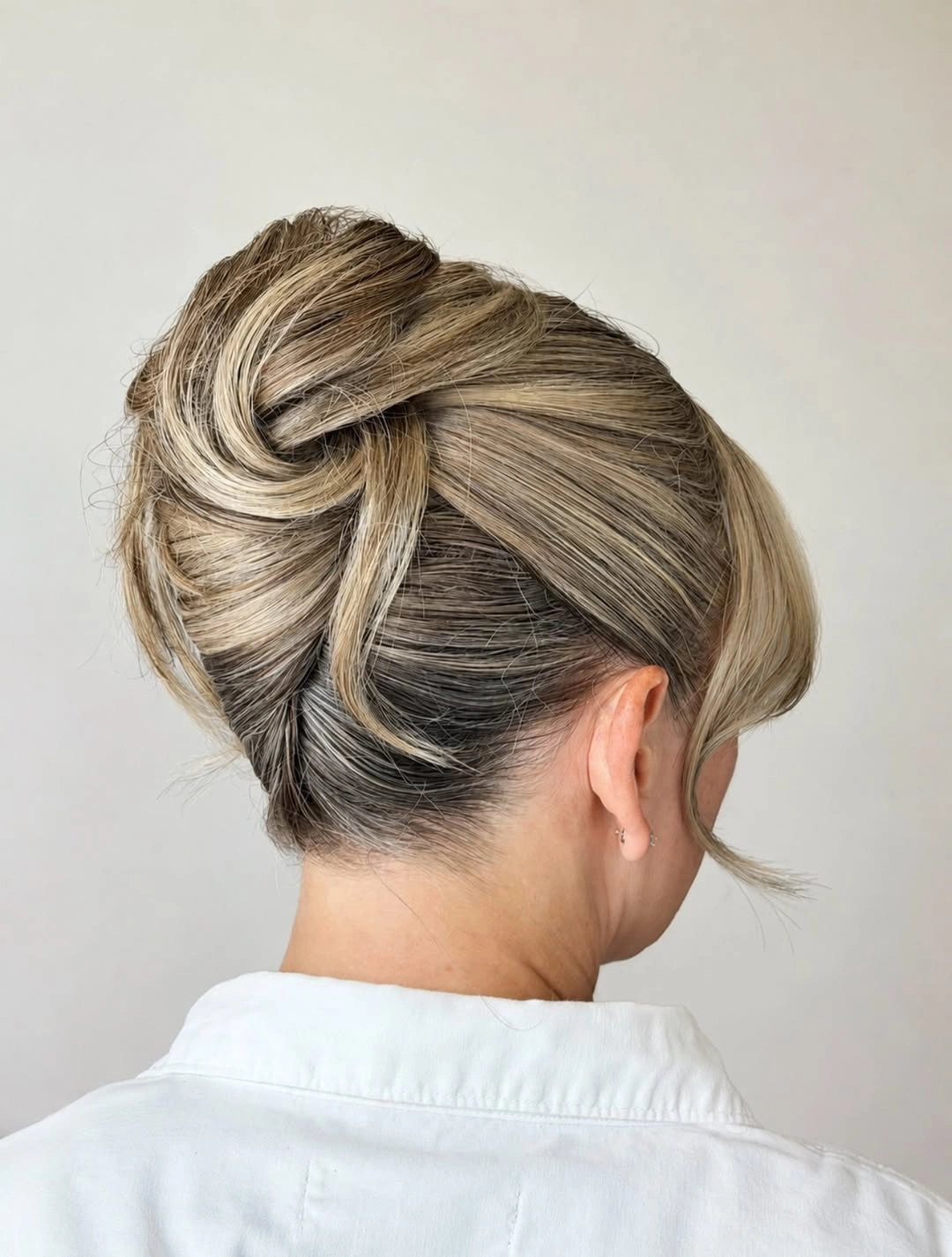 Fall hairstyles for wedding guests 2026 Elegant Twisted Chignon with Soft Face-Framing Pieces