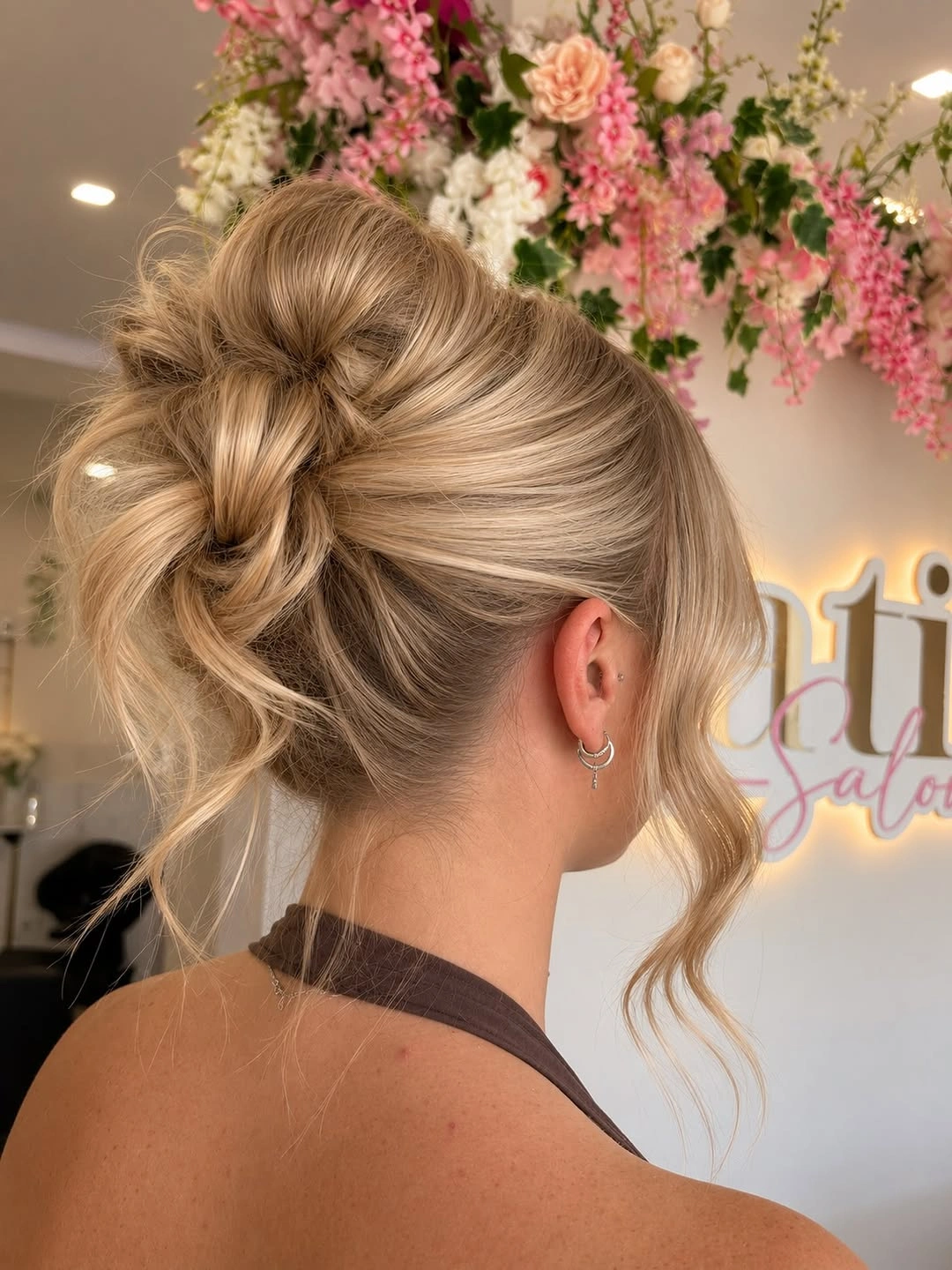 Fall hairstyles for wedding guests 2026 Elegant Blonde Twisted Bun with Soft Romantic Finish