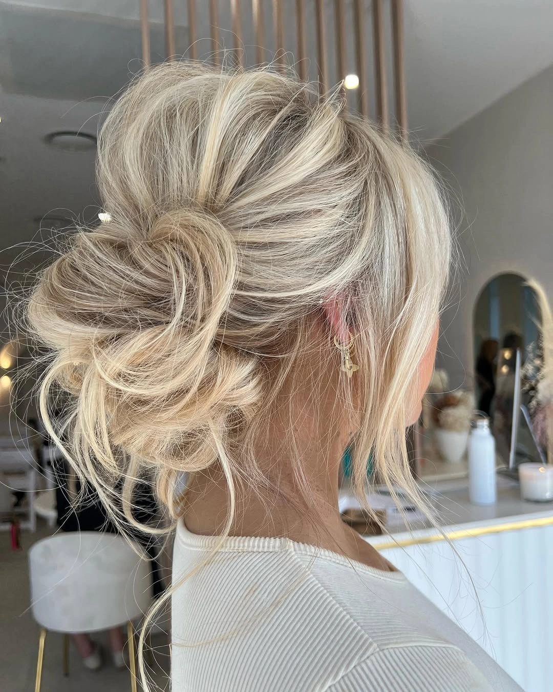 Fall hairstyles for wedding guests 2026 Airy Blonde Textured Bun with Effortless Volume