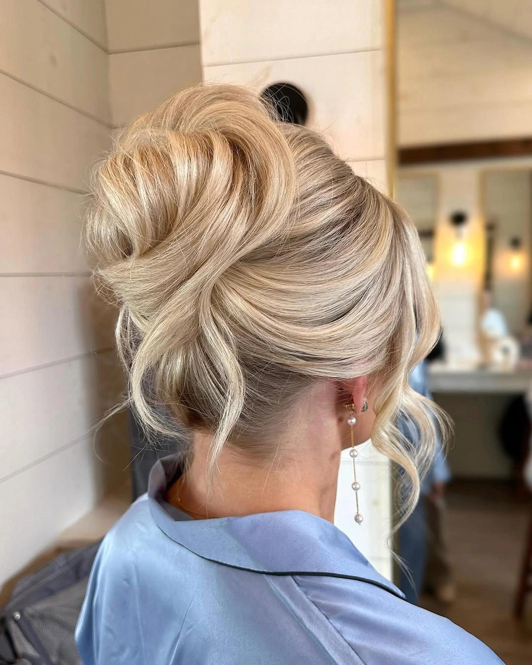 Fall hairstyles for wedding guests 2026 Classic Blonde French Twist with Soft Curtain Fringe
