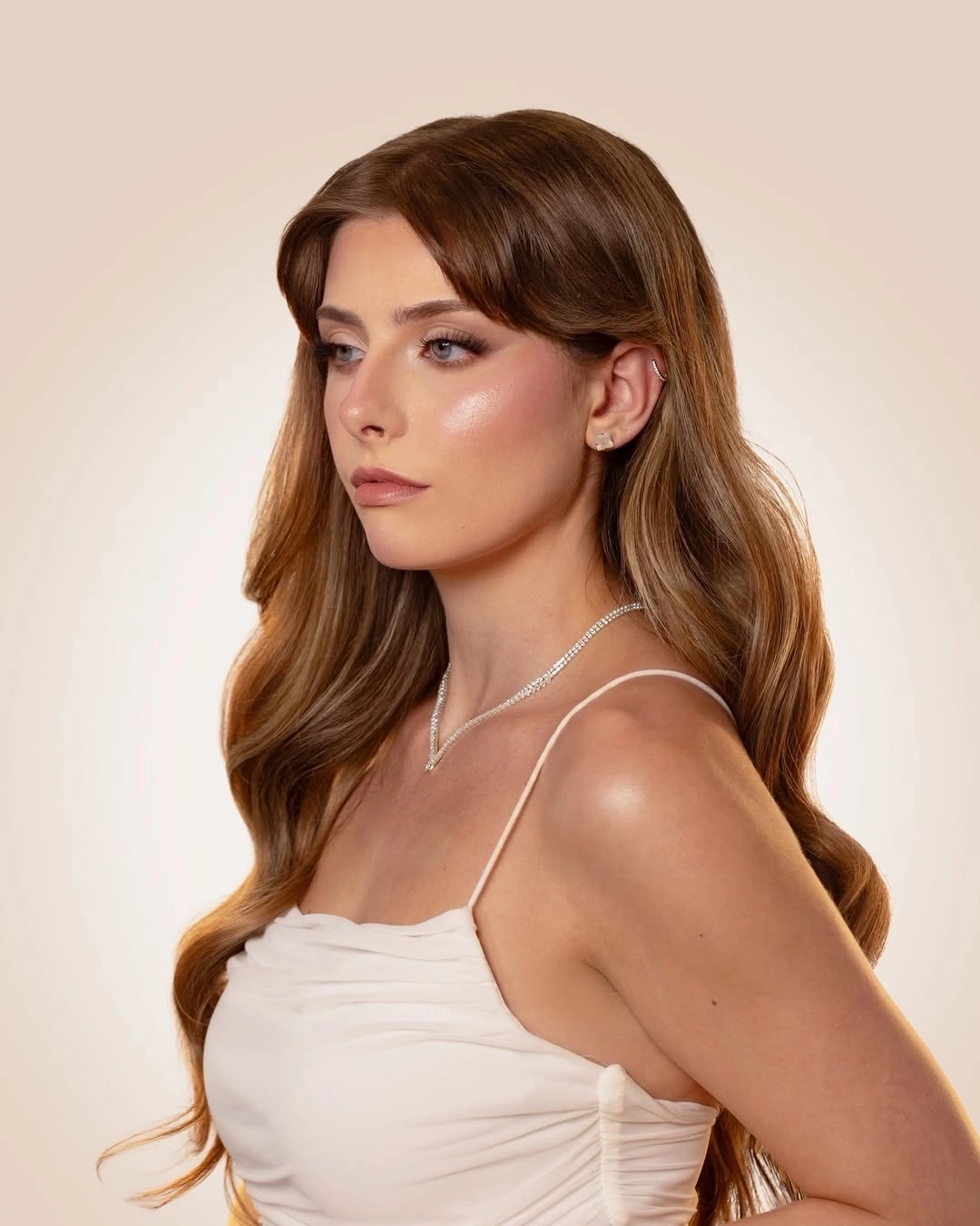 Fall hairstyles for wedding guests 2026 Glossy Hollywood Waves with Curtain Bangs