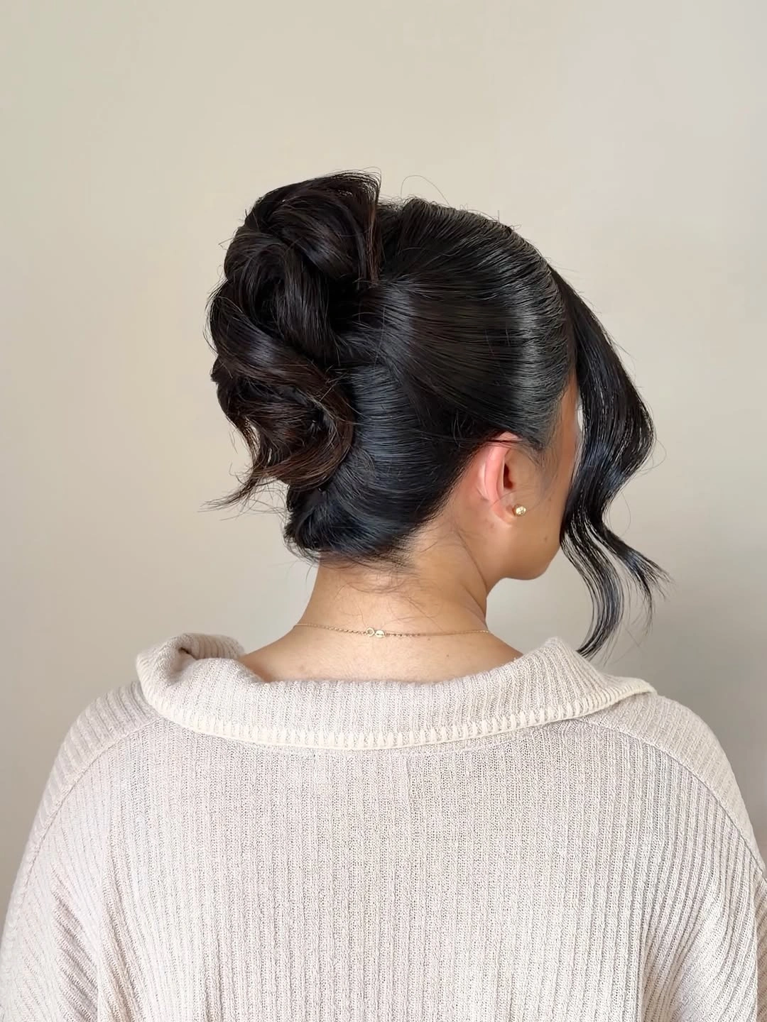 Fall hairstyles for wedding guests 2026 Modern Sculpted Low Bun with Sleek Finish