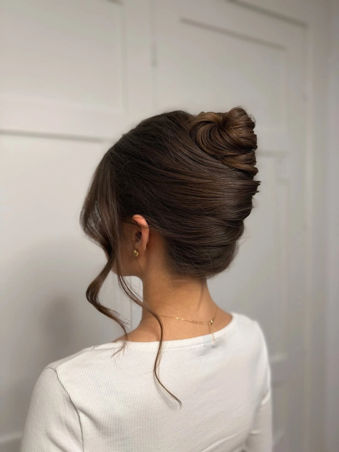 Fall hairstyles for wedding guests 2026 Soft French Twist Updo with Wispy Face-Framing Layers