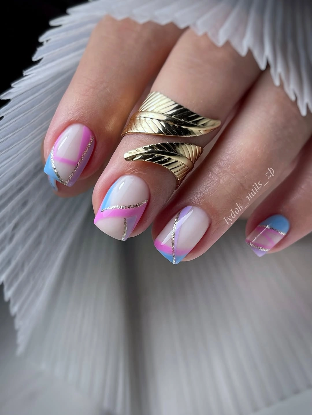 short sheer nails with pastel diagonal french tips in pink blue purple