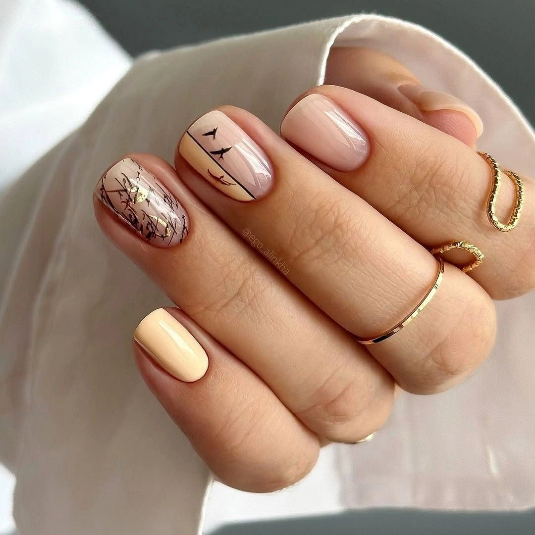 cream short nails with brown sketch details and nude accents